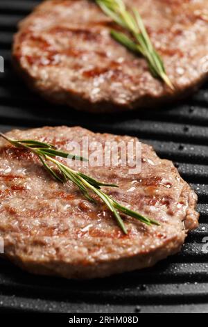 Le polpettine di manzo per un hamburger vengono fritte con spezie su una griglia elettrica intelligente. Cucinare hamburger fatti in casa. Ingredienti per hamburger. Foto Stock
