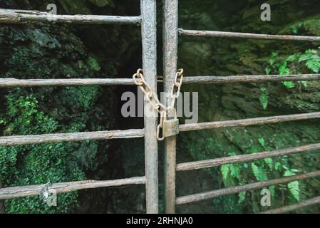 Pair of Gates to an old disused mineshaft locked with a padlock and chain Stock Photo