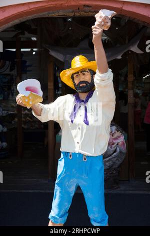 Key West, Florida, USA. Figure of a bearded man holding conch shells outside the Key West Shell Warehouse, Mallory Square, Old Town. Stock Photo