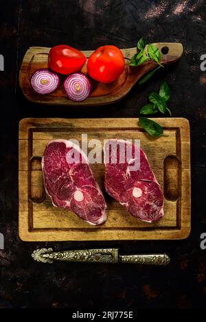 Costolette di agnello presentate con gli ingredienti sul tavolo Foto Stock