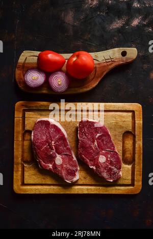 Costolette di agnello presentate con gli ingredienti sul tavolo Foto Stock