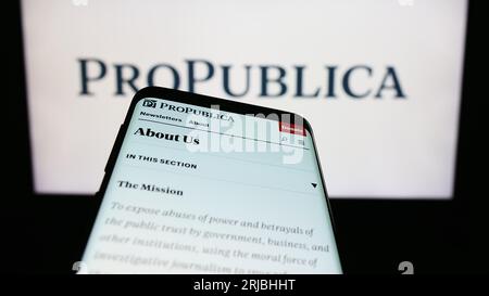 Mobile phone with website of US media company Pro Publica Inc. on screen in front of business logo. Focus on top-left of phone display. Stock Photo