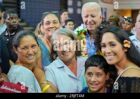 Lahaina, Stati Uniti. 21 agosto 2023. Il presidente degli Stati Uniti Joe Biden, in alto a destra, scatta un selfie con i residenti durante una riunione della comunità in seguito a incendi che hanno travolto la Maui occidentale al Lahaina Civic Center, 21 agosto 2023 a Lahaina, Maui, Hawaii. Credito: Adam Schultz/White House Photo/Alamy Live News Foto Stock