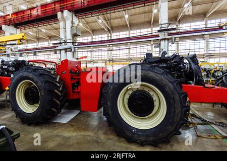 Processo di montaggio dei trattori agricoli in officina industriale. Foto Stock