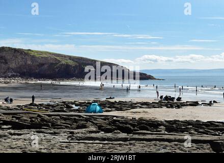 Eye level view along Dunraven Bay in July, Summertime, with lots of people and the odd tent. Dunraven Bay also has another name, Southerndown Beach Stock Photo