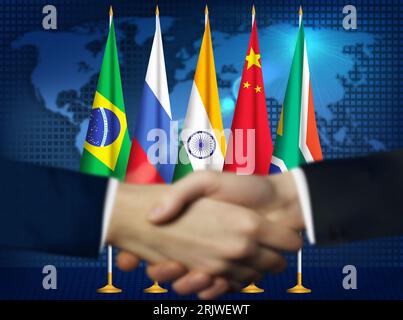 Two person shaking hands in front BRICS countries flags.Brazilian,Russian,Indian,Chinese,South African flags together Stock Photo