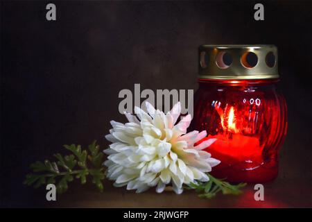 Grave candle lantern and flower on dark grunge background Stock Photo