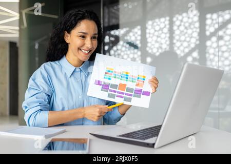 Rapporti di incontri di lavoro online, donna d'affari di successo che mostra un grafico grafico con fotocamera per laptop con buoni risultati positivi sul posto di lavoro, donna ispanica in videochiamata. Foto Stock