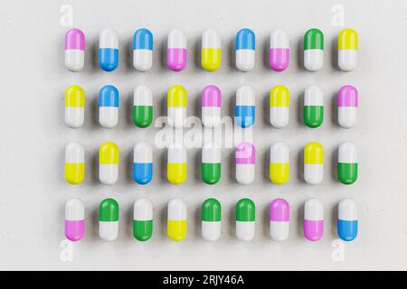 Concetto di farmacia: Pillole/capsule di colore diverso disposte su un foglio di carta. Foto Stock