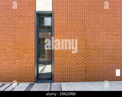 red brick wall of old renovated building with large window. architectural detail. Stock Photo