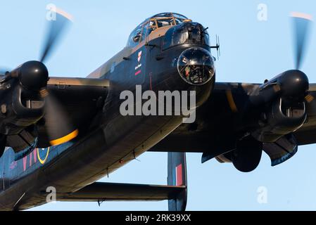 RAF Battle of Britain Memorial Flight Avro Lancaster bomber plane taking off low at London Southend Airport, Essex, UK. Bomb-aimers nose blister Stock Photo