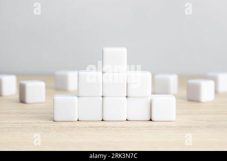 Pyramid of blank white cube blocks on table. Template mockup Stock Photo