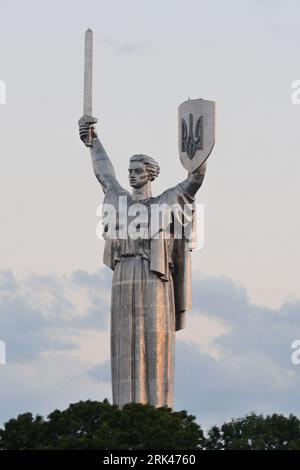 Kiev, Ucraina. 23 agosto 2023. Lo stemma dell'Ucraina sullo scudo del Monumento della Patria è svelato a Kiev. Oggi, l'Ucraina celebra il suo 32 ° giorno dell'indipendenza. In precedenza, lo stemma dell'URSS era stato posto sullo scudo, ma nelle condizioni della guerra tra Russia e Ucraina, fu presa la decisione di decomunizzarlo e sostituirlo con lo stemma dell'Ucraina "Tridente". Credito: SOPA Images Limited/Alamy Live News Foto Stock