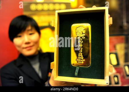 Bildnummer: 53650684 Datum: 07.12.2009 Copyright: imago/Xinhua (091207) -- PECHINO, 7 dicembre 2009 (Xinhua) -- Un salesclerk mostra una barra d'oro con il segno della tigre al grande magazzino Caibai di Pechino, capitale della Cina, 7 dicembre 2009. Le lingotti d'oro con il segno della tigre che vanno da 50 grammi, 100 grammi, 200 grammi, 500 grammi e un chilogrammo saranno in vendita presso il negozio l'8 dicembre. L'anno del 2010 è l'anno della Tigre secondo il calendario lunare tradizionale cinese. (Xinhua) (wyx) (1)CHINA-BEIJING-GOLD BAR-ANIMAL SIGN (CN) PUBLICATIONxNOTxINxCHN Objekte China Astrologie Horoskop Jahr Foto Stock