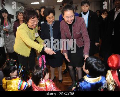 Bildnummer: 53679692  Datum: 19.12.2009  Copyright: imago/Xinhua (091219) -- MACAO, Dec. 19, 2009 (Xinhua) -- Accompanied by Tatiana Lau (R, central row),  of  the Macao Special Administrative Region (SAR) chief executive, Liu Yongqing (C, central row),  visits the S. Joao nursery affiliated to the Mothers Program of Macao SAR in south China on Dec. 19, 2009. to attend the celebrations marking the 10th anniversary of Macao s return to the motherland. (Xinhua/Fan Rujun) (lyx) (2)CHINA-MACAO-LIU YONGQING-NURSERY-VISIT (CN) PUBLICATIONxNOTxINxCHN People Politik Jahrestag Übergabe kbdig xsk 2009 q Stock Photo