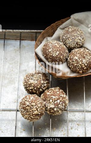 A traditional rustic basket filled with freshly baked small buns Stock Photo