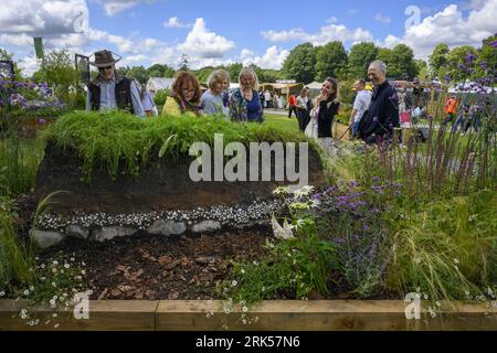 I visitatori guardano e chiacchierano sul design della partecipazione al concorso per i letti rialzati dell'orticoltura - RHS Tatton Park Flower Show 2023 Showground, Cheshire, Inghilterra, Regno Unito. Foto Stock