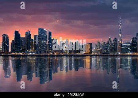 Stunning view of the illuminated Dubai skyline at sunset with the magnificent Burj Khalifa. Stock Photo