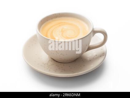 Fresh hot creamy coffee in light porcelain cup on white. Stock Photo