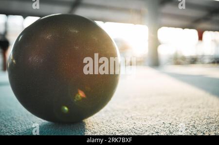 Gymnastics ball on floor for sports, fitness and lens flare with mockup for exercise, performance or rhythmic dance. Light, ground and aerobics Foto Stock