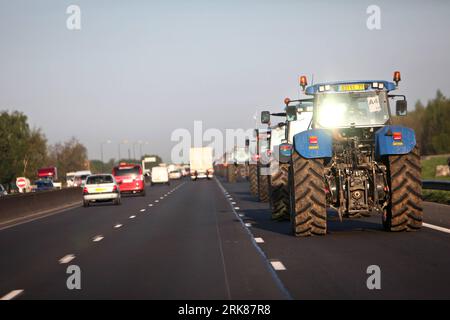 Bildnummer: 53984600  Datum: 27.04.2010  Copyright: imago/Xinhua (100428) -- PARIS, April 28, 2010 (Xinhua) -- French farmers drive their tractors on a highway to Paris on April 27, 2010, as they demonstrate against wages cut and to denounce the European Farm Policy. Thousands of French grain farmers took on Pairs streets on Tuesday to protest the lower grain price and demand governmental support on European agriculture regulation, which has delayed much traffic at major entry points to Paris. (Xinhua/Thibault Camus) (ypf) (5)FRANCE-PARIS-FARMER-TRACTOR-PROTEST PUBLICATIONxNOTxINxCHN Politik k Stock Photo