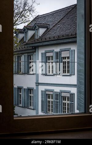 Architectural detail of historical houses seen through a huge window of a modern building, in the  Old Town, Basel, Switzerland Stock Photo