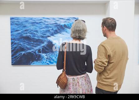 Skagen, Danimarca, 19 maggio 2023: I visitatori guardano i dipinti in galleria Foto Stock