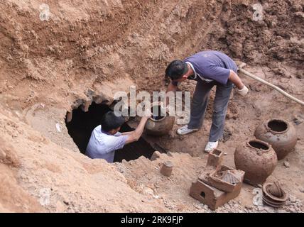 Bildnummer: 54189255  Datum: 26.06.2010  Copyright: imago/Xinhua (100629) -- JIAOZUO, June 29, 2010 (Xinhua) -- Two archaeological workers unearth the relics from one of the two newly-excavated tombs dated back to eastern Han dynasty (25-220 AD), in Jiaozuo City, central China s Henan Province, June 26, 2010. A 7-storey painted pottery joint storage building, together with some 70 pieces of pottery wares as the burial accessories, has been disintered in a 3-day protective excavation. (Xinhua/Cheng Quan) (px) (4)CHINA-HENAN-ARCHAEOLOGICAL EXCAVATION-BURIAL TOMB-EASTERN HAN DYNASTY(CN) PUBLICATI Stock Photo