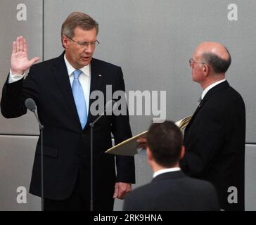 100702 -- BERLIN, July 2, 2010 Xinhua -- Newly elected German President Christian Wulff L raises his arm during a sworn-in ceremony in Berlin July 2, 2010. Christian Wulff, nominated by Angela Merkel s coalition government, won the German presidential election on Wednesday evening. On the right:  Norbert Lammert Xinhua/Luo Huanhuan nxl GERMANY-BERLIN-WULFF-INAUGURATION PUBLICATIONxNOTxINxCHN Stock Photo