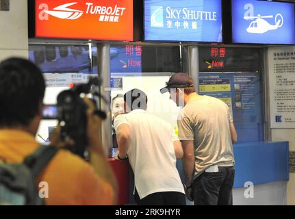 Bildnummer: 54199541  Datum: 03.07.2010  Copyright: imago/Xinhua (100703) -- HONG KONG, July 3, 2010 (Xinhua) -- Passengers consult the flight information as regular air service of the Hong Kong-based helicopter service company Sky Shuttle was suspended following the accident in Hong Kong, south China, July 3, 2010. A helicopter, which belonged to Sky Shuttle, crashed into the sea area between the Hong Kong Island and the Kowloon Peninsular on Saturday noon, and all 13 persons onboard have been rescued, sustaining slight injuries, the city s police told Xinhua. (Xinhua/Huang Xiaoyong) (wjd) (6 Stock Photo