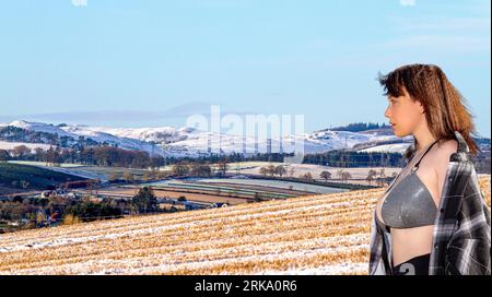 Immagine modificata digitalmente e modificata in Photoshop di una donna in un paesaggio invernale in Scozia, Regno Unito Foto Stock