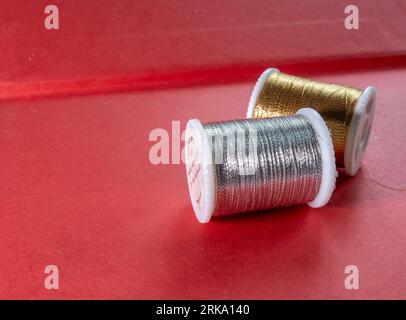 Spools of gold and silver metallic sewing thread, USA Stock Photo