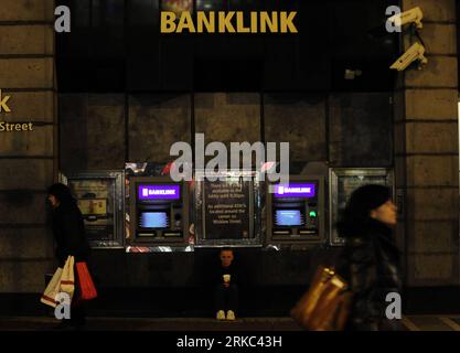 Bildnummer: 54661513 Datum: 20.11.2010 Copyright: imago/Xinhua (101120) -- DUBLINO, 20 novembre 2010 (Xinhua) -- Una donna implora accanto ai bancomat delle Allied Irish Banks (AIB) a Dublino, Irlanda, 20 novembre 2010. A Dublino sono in corso colloqui tra il governo irlandese e le delegazioni dell'Unione europea, il Fondo monetario internazionale (FMI) e la Banca centrale europea su un possibile pacchetto di aiuti di decine di miliardi di euro per il paese colpito dal debito. (Xinhua/Zeng Yi) (zw) IRLANDA-DUBLINO-CRISI DEL DEBITO PUBLICATIONxNOTxINxCHN Wirtschaft Irland Wirtschaftskrise Finanzkrise Banken Land leute AR Foto Stock
