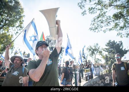 Kedumim, Israel. 24th Aug, 2023. Protestors chant slogans during a demonstration of 'Brothers in Arms', Israeli reservists organization against the judicial overhaul in front of Bezalel Smotrich - Minister of Finance house in the occupied West Bank settlement of Kedumim. Credit: SOPA Images Limited/Alamy Live News Stock Photo