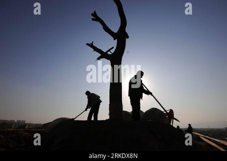 Bildnummer: 55014432  Datum: 11.03.2011  Copyright: imago/Xinhua (110311) -- LINFEN, March 11, 2011 (Xinhua) -- Workers earth up newly-planted trees on the site of the Fenhe River Park which is under speedy construction in Linfen city of north China s Shanxi Province, March 11, 2011. Linfen, which used to be one of China s most polluted cities due to its coal and iron industries, has now seen blue sky and green waters again after 5 years of intensified efforts in pollution control. (Xinhua/Fan Minda) (llp) CHINA-LINFEN-POLLUTION CONTROL (CN) PUBLICATIONxNOTxINxCHN Gesellschaft Umweltschutz kbd Stock Photo