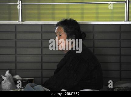 Bildnummer: 55045088  Datum: 19.03.2011  Copyright: imago/Xinhua (110320) -- FUKUSHIMA, March 20, 2011 (Xinhua) -- A Japanese woman sits inside a sports park used as a makeshift shelter in Fukushima, Japan, March 19, 2011. Residents around the Fukushima No. 1 nuclear power plant were evacuated to shelters to avoid radioactive hurt after nuclear leakage. Evacuees here were waiting in calm and orderliness for going back home. (Xinhua/Huang Xiaoyong) (ybg) JAPAN-FUKUSHIMA-SHELTER-LIFE PUBLICATIONxNOTxINxCHN Gesellschaft Japan Erdbeben Naturkatastrophe Tsunami Notunterkunft Einwohner kbdig xkg 201 Stock Photo