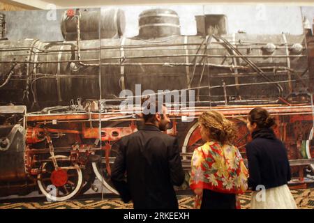 Bildnummer: 55248329  Datum: 08.04.2011  Copyright: imago/Xinhua (110408) -- BUCHAREST, April 8, 2011 (Xinhua) -- look at the life-size canvas painting depicting the biggest steam locomotive in Romania, an 1889 Pacific 230 series, in Bucharest, capital of Romania, April 8, 2011. The painting by Romanian artist Alexandru Bunescu measures 20 meters in length and 4.5 meters in height. It will be auctioned next week and is widely expected to reach a value of up to 60,000 euros. (Xinhua/Gabriel Petrescu) (wjd) ROMANIA-BUCHAREST-PAINTING-LOCOMOTIVE PUBLICATIONxNOTxINxCHN Gesellschaft Ausstellung kbd Stock Photo