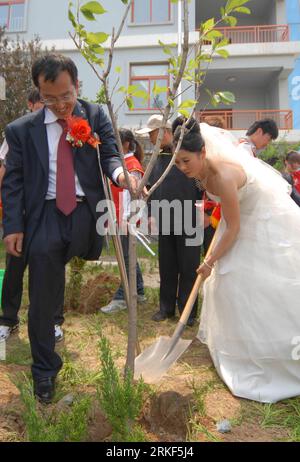 Bildnummer: 55348611 Datum: 15.05.2011 Copyright: imago/Xinhua (110515) -- WEIFANG, 15 maggio 2011 (Xinhua) -- Una coppia sposata pianta un albero della felicità durante un matrimonio di massa per disabili a Weifang, provincia dello Shandong della Cina orientale, 15 maggio 2011. Il primo matrimonio di massa per i disabili, con 18 coppie presenti, si è tenuto a Weifang City domenica, la ventunesima giornata Nazionale dell'assistenza ai disabili, con il tema migliorare la vita dei disabili, proteggere i diritti e gli interessi dei disabili. (Xinhua/Cao Lianghua)(zxh) CINA-SHANDONG-GIORNATA NAZIONALE DI ASSISTENZA AL COLLETTIVO DISABILI NOI Foto Stock