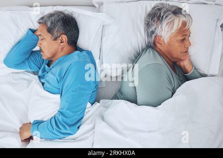 Sleeping, above and a senior couple in a bed with fatigue in a marriage together. Top view, relax and a tired elderly man and woman in the bedroom for Foto Stock