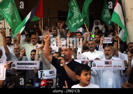 Ondata palestinese di bandiere islamiche verdi e nazionali di Hamas durante una protesta a sostegno di Gerusalemme e della Cisgiordania, dopo la preghiera del venerdì davanti alla moschea di al Kabeer a Khan Younis, nella Striscia di Gaza meridionale, venerdì, agosto. 25, 2023. Foto di Ismael Mohamad/UPI credito: UPI/Alamy Live News Foto Stock