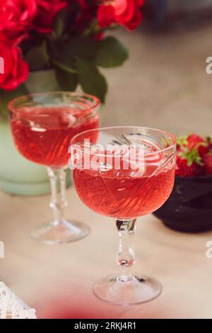 Red sparkling strawberry wine with roses outdoor. Romantic, precious moment concept. Stock Photo