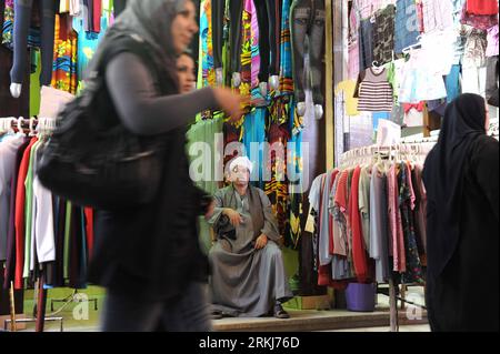 Bildnummer: 56022985  Datum: 14.09.2011  Copyright: imago/Xinhua (110918) -- CAIRO, Sept. 18, 2011 (Xinhua) -- A cloth shopkeeper sits in front of his shop at the Wekalet El Balah market in Cairo, capital of Egypt, Sept. 14, 2011. Wekalet El Balah is one of the major local markets in Egypt that presents a huge variety of goods and products at a very good price. It s located in the intersection of 26th street and the Nile in Cairo. This area is known as Boulak Abu El Ela and is famous for cotton trade. In earlier times, ships used to arrive in Cairo at Wekalet El Balah, carrying large amounts o Stock Photo