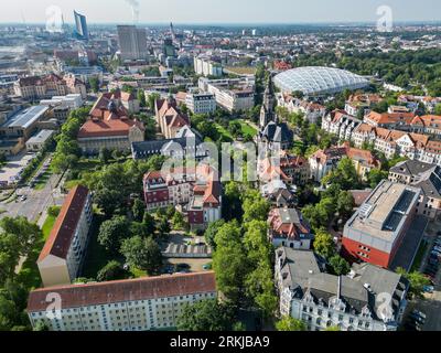 Leipzig, Germany. 23rd Aug, 2023. View of the district 'Zentrum Nord' with the Michaeliskirche at the Nordplatz and the tropical hall Gondwanaland of the Leipzig Zoo. (Aerial view with drone) Credit: Jan Woitas/dpa/Alamy Live News Stock Photo