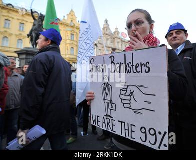 Bildnummer: 56184165  Datum: 15.10.2011  Copyright: imago/Xinhua (111016) -- ZAGREB, Oct. 16, 2011 (Xinhua) -- A protestor holds a placard during an anti-capitalism protest in Zagreb, capital of Croatia, Oct. 15, 2011. Several thousand protesters took to the streets here on Saturday to join the global Occupy protests. (Xinhua/Miso Lisanin) CROATIA-ZAGREB-ANTI-CAPITALISM PROTEST PUBLICATIONxNOTxINxCHN Gesellschaft Politik Wirtschaft Protest Demo Finanzkrise Finanzwirtschaft Wirtschaftskrise Krise Banken xbs x0x 2011 quer premiumd  o0 Wirtschaft Banken Bankenprotest Anti Kapitalismus Antikapital Stock Photo