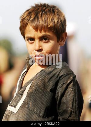 Bildnummer: 56215146  Datum: 25.10.2011  Copyright: imago/Xinhua (111025) -- NOWSHERA, Oct. 25, 2011 (Xinhua) -- An Internally displaced boy whose family fled from Khyber tribal region due to military operation, reacts as he stands near his makeshift tent at Jalozai camp on the outskirt of northwest Pakistan s Nowshera on Oct. 25, 2011. Families continued to evacuate from Bara, a troubled area of Pakistani tribal region Khyber as the Pakistani security forces prepared to launch an operation against militants, local media reported. (Xinhua/Umar Qayyum) (srb) PAKISTAN-NOWSHERA-IDPS PUBLICATIONxN Stock Photo