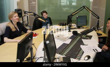 Bildnummer: 56883111  Datum: 22.12.2011  Copyright: imago/Xinhua (120113) -- BEIJING, Jan. 13, 2012 (Xinhua) -- Elyse Ribbons (L) reacts during the recording of the radio program Laowai Kandian in a studio at China Radio International headquarters in Beijing, China, Dec. 22, 2011. On a bullet train traveling from Beijing to Tianjin, an American blonde chowed down on a hamburger and fries. She had to polish off her dinner within the 30-minute s journey. Upon arrival she had to rush through the train station to make it over to the Tianjin TV headquarters for the filming of the finale of the fore Stock Photo