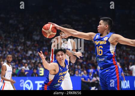 Bocaue, Philippines. 25th Aug, 2023. Karl Anthony Towns (32, White) battles for ball possession against Dwight Ramos (24, Blue) and Roger Ray Pogoy (16, Blue). (Photo by Dennis Jerome Acosta/Pacific Press) Credit: Pacific Press Media Production Corp./Alamy Live News Stock Photo