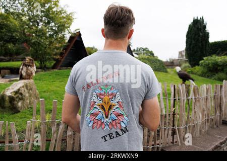 Detmold, Germany. 16th Aug, 2023. Falconer Benjamin Aschmann stands on the grounds of the Adlerwarte Berlebeck. About 200 different birds of 40 different species live in the zoo. Credit: Friso Gentsch/dpa/Alamy Live News Stock Photo