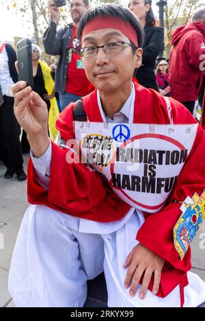 Paris, France, Japanese Man in Traditional Costume, Holding protest Sign in Large Crowd of People, Protesting Nuclear Energy, Reacting to Fukishima Accident, Place de la République, 2014 Stock Photo