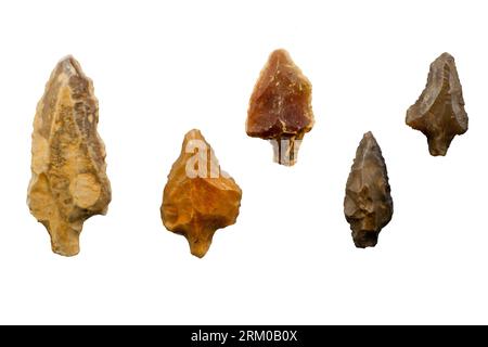 Collection of Paleolithic tanged points made of flint from the Pleistocene / Ice Age / Glacial Epoch found in Morocco against white background Stock Photo